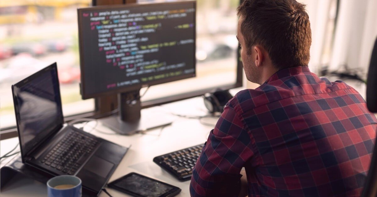 software developer sitting in front of a laptop