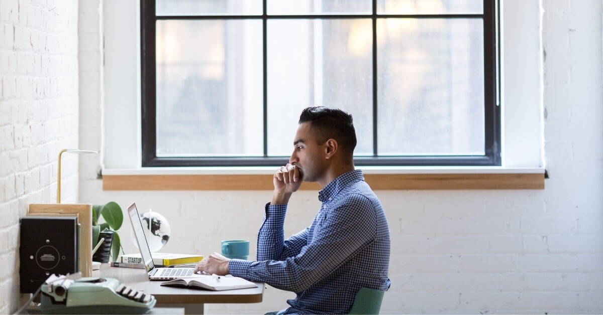 remote software developer sitting at home at his desk alone