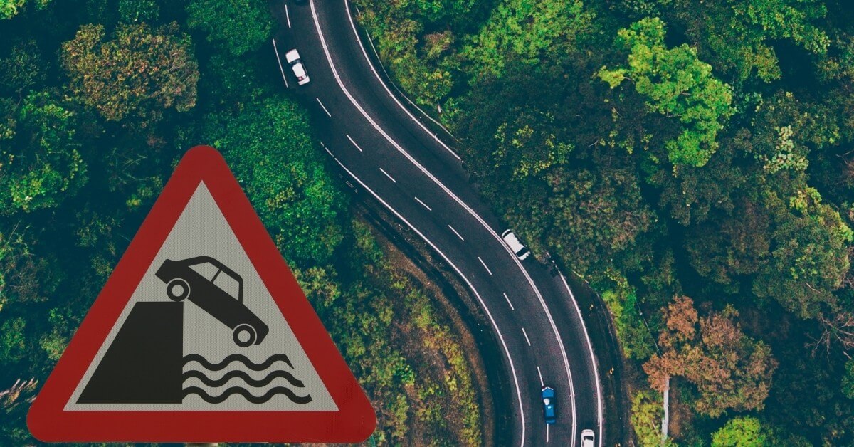 sign showing a car dirving off a cliff
